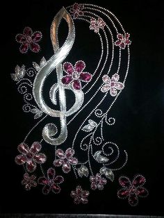 a music note with pink flowers and butterflies on black velvet background, decorated with swarovs