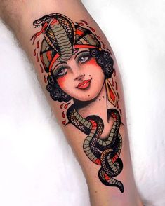 a woman with a snake tattoo on her leg