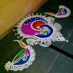 two colorful rangolii designs on the ground