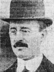 an old black and white photo of a man wearing a hat