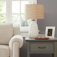 a living room scene with focus on the end table and lamp next to the chair