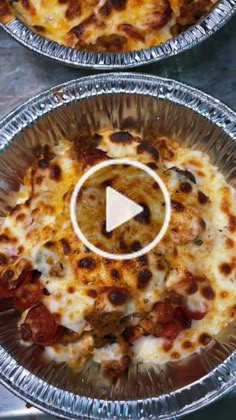 two pizza pies sitting on top of tin foil pans covered in cheese and pepperoni