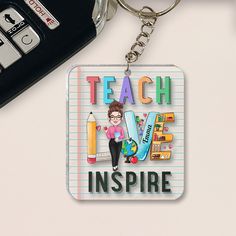 a keychain that says teach love inspire with a girl holding a pencil in her hand