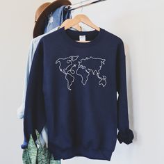 World Map Airplane Travel Sweatshirt for Men and Women, Unisex Crewneck Travel Sweater SIZE UP for an OVERSIZED Fit (see size chart in listing photos) Looking for additional travel or outdoor apparel? Check these out: https://www.etsy.com/shop/TheGraphicPeach?ref=seller-platform-mcnav§ion_id=31675954 Our shop uses direct-to-garment printing to make our products. The design ink is sprayed on, then allowed to soak into the fibers of the garment. This process yields fine quality prints and a smooth Travel Sweatshirt, Travel Sweater, World Map Travel, Adventure Outfit, Airplane Travel, Adventure Explore, Gildan Sweatshirts, Travel Shirts, Limassol