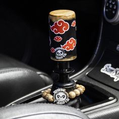 the steering wheel knob is decorated with skulls and flowers