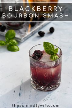 blackberry bourbon smash in a glass with mint garnish