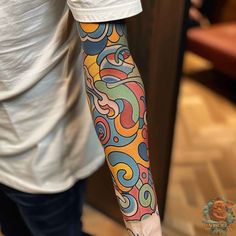 a man with a colorful tattoo on his arm