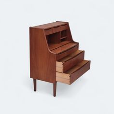 a small wooden desk with drawers on the bottom and one drawer open to show its contents