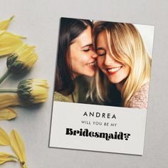 two women are hugging each other in front of yellow flowers and the caption reads, andrea will you be my bridesmaid?