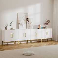 a living room with a white and gold sideboard next to a large painting on the wall