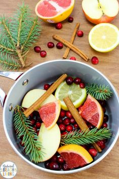 a pan filled with fruit and spices on top of a wooden table