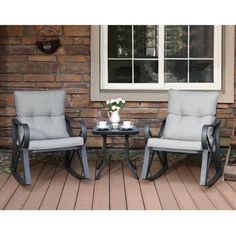 two chairs sitting on top of a wooden deck