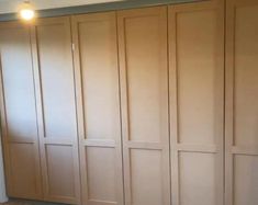 an empty room with wooden closets and tile flooring