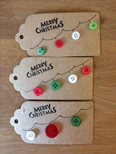 two tags with christmas buttons attached to them