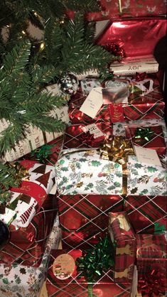 presents under the christmas tree are wrapped in red and green paper