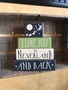 i love you to neverland and back sign on wooden shelves in a store display