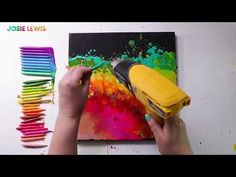 a person is painting with colored crayons and a yellow blow dryer on the wall