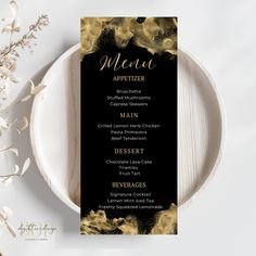 a black and gold menu card on a white plate