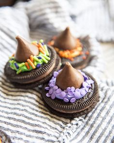 three decorated cookies sitting on top of a table