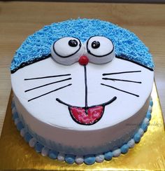 a birthday cake decorated to look like a cat