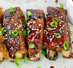 ribs covered in bbq sauce and garnished with green onions