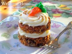 a close up of a plate of food with a fork and spoon on it that says welcome home