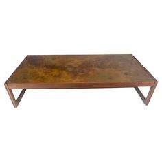 a coffee table with a metal top and wooden legs