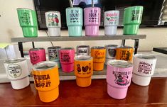 there are many different colored tumblers on the table with each one's own name