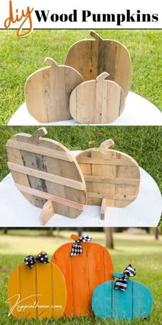 three wooden pumpkins sitting on top of a white cloth covered table in the grass