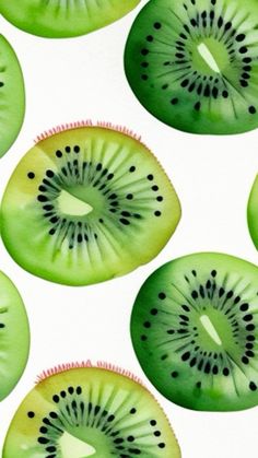 slices of kiwi fruit are arranged on a white background with black dots in the center