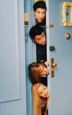 the cast of friends hanging out in front of a blue door with their heads sticking out