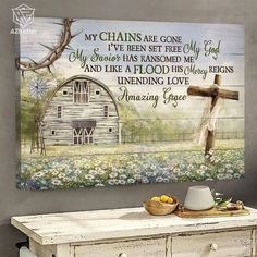 an old dresser with a cross on it and flowers in the foreground, next to a painting that says my chains are gone i've been set free