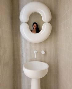 a woman is seen in the mirror of a bathroom