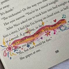 an open book with writing on it and some colorful ink splatters in the pages