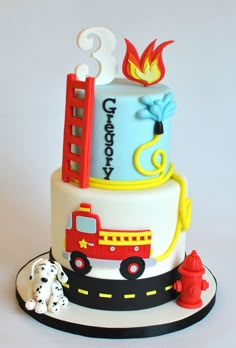 a birthday cake with a firetruck and dog on top