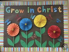 a bulletin board with paper flowers and butterflies on it that says growing christ in the center