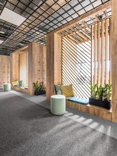 an empty room with wooden walls and plants on the windows sills in front of them