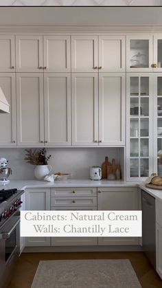 a kitchen with white cabinets and an area rug