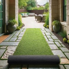 an outdoor living area with grass and plants