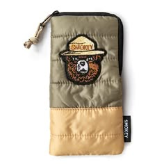 a small wallet with a bear wearing a hat on it's front and side