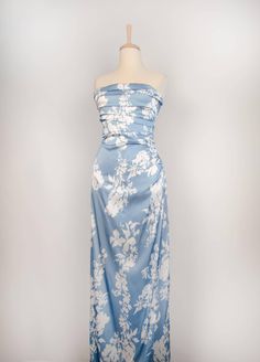 This floral silk wrap dress is versatile and perfect for a variety of occasions. Whether you're searching for a floral bridesmaid dress, a silk evening gown, or a custom silk dress, this piece can be tailored to fit your specific needs. The delicate floral print and the sheen of the silk ensure that this dress is not only fashionable but also timeless. The Dress Details - Material: 50% Silk, 30% Cotton, 20% Polyester - Floral print design adds a timeless, feminine touch - Back zipper and elegant Silk Maxi-length Floral Dress For Garden Party, Floor-length Silk Midi Dress With Floral Print, Blue Floral Print Silk Dress, Luxury Silk Floral Dress, Luxury Silk Floral Print Evening Dress, Silk Evening Gown, Floral Bridesmaid Dresses, Silk Wrap Dresses, Floral Print Design