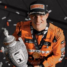 a man in an orange shirt holding a trophy