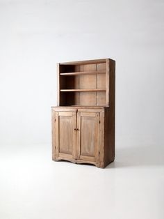 an old wooden cabinet sitting on top of a white floor