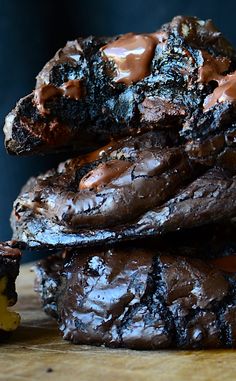 chocolate cookies stacked on top of each other with caramel drizzled on them