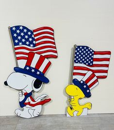 two cartoon characters with american flags on their heads, one in the shape of a dog