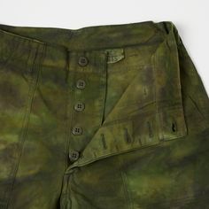 These camo shorts from Buzz Rickson’s are a brilliant reinterpretation of a vintage U.S military, standard issue fatigue short. With a loose straight fit and a high rise button fly, these shorts are very comfortable to wear, and the 100% cotton fabric allows for a lot of breathability. The tie dye design has a subtle vintage fade which adds to the authenticity of these shorts. Double felled seams provide excellent durability, and two front patch pockets are met with two flap back pockets for con Military Style Camouflage Shorts, Military Style Camouflage Cotton Cargo Shorts, Military Camouflage Shorts With Side Pockets, Military Camouflage Shorts For Outdoor, Military Camouflage Cotton Shorts, Camo Shorts, Green Tie, Tie Dye Designs, Camo Print