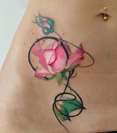 a woman's stomach with a rose tattoo on it