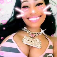 a woman with pink and black stripes on her chest smiling at the camera while wearing a necklace