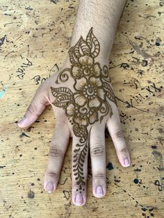 a person's hand with henna tattoos on it