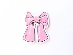 a pink bow sticker sitting on top of a white surface